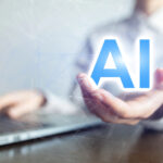 Hand laptop letters AI