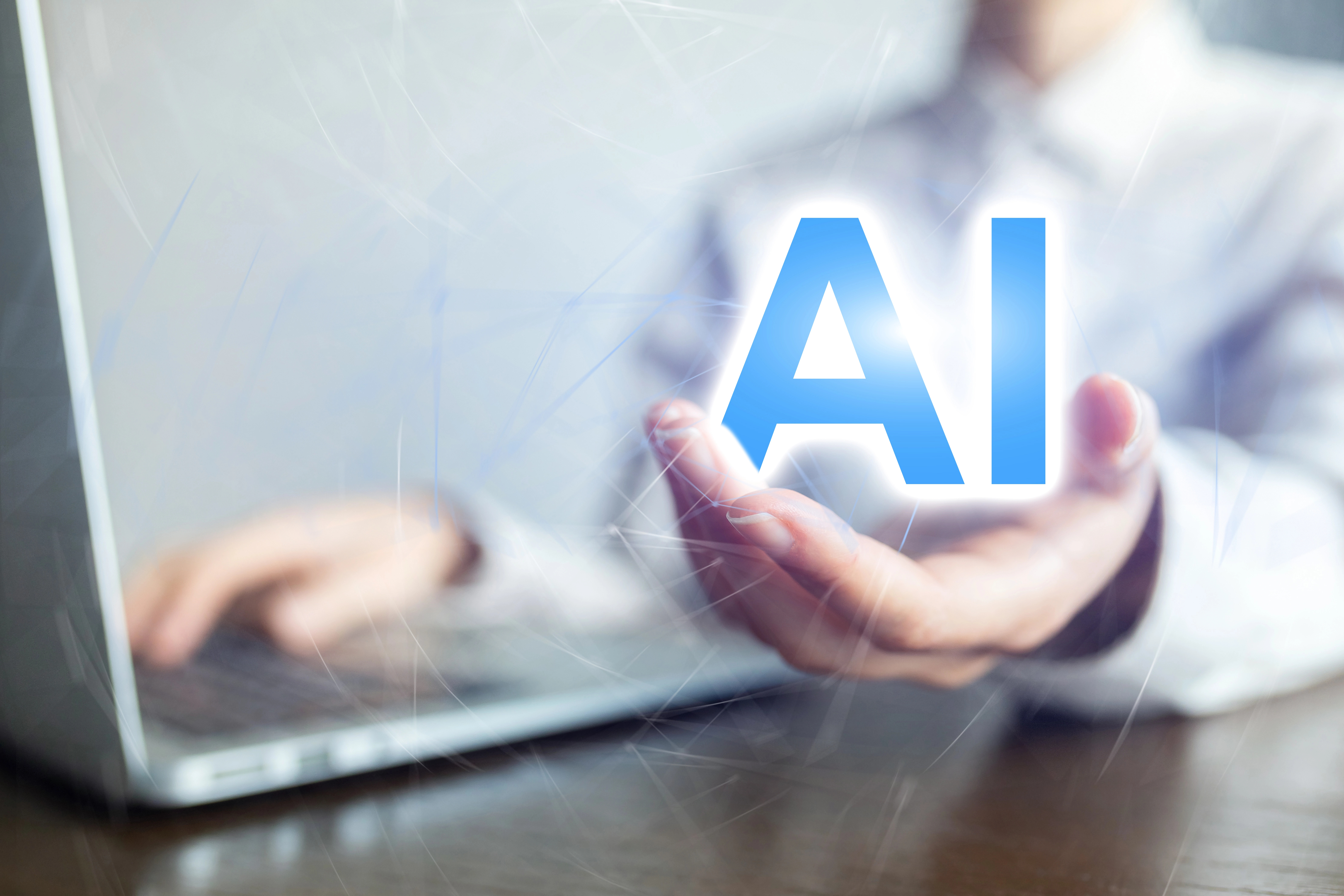 Hand laptop letters AI